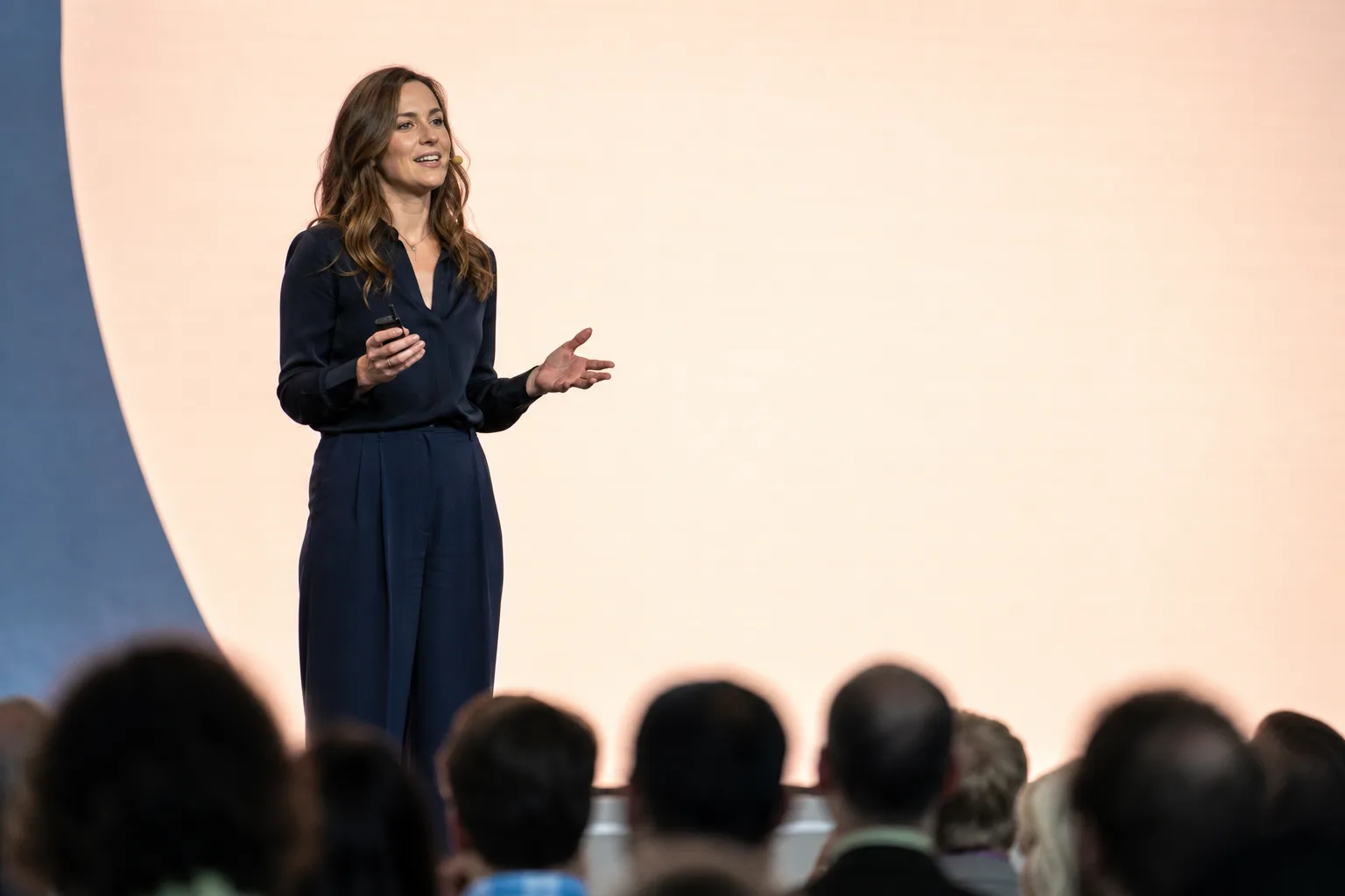 A speaker presenting on stage in front of an audience